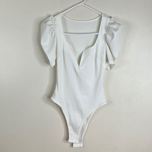 Deep V short sleeve, white bodysuit #2 long sleeve, red thong, bodysuit.